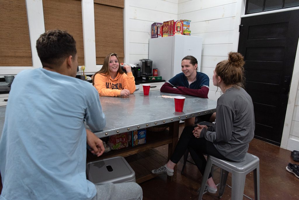 Victor Ventura (left), Anna Raymond, William Restis, and Katie Dowling discuss their highs, lows, and ways to grow during their nightly reflection.