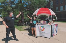 Leaders of Students Ending Rape Culture (SERC) high-five each other on the Illinois State Quad.