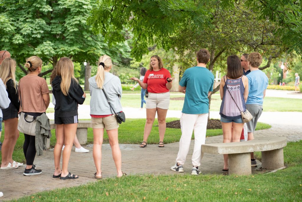 Preview guide gives a group of students and families a tour of the Quad. 