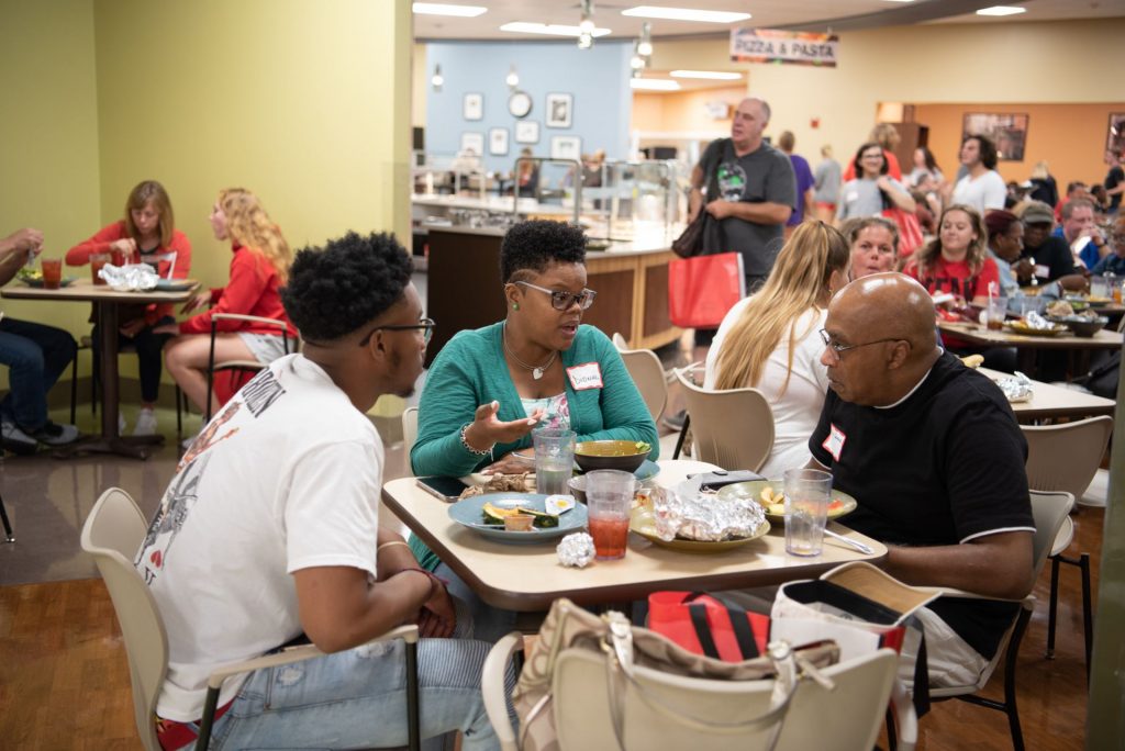 Students and families enjoy a free lunch at Watterson Dining Commons