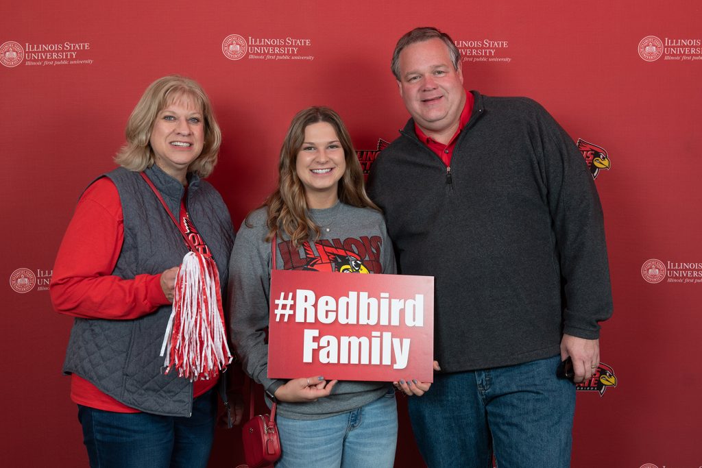 family posing together with ISU signs