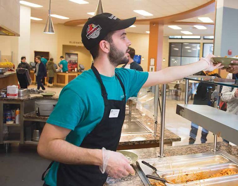 Dining Hall worker serving a customer