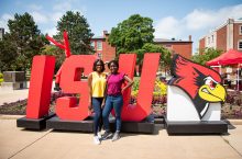Students standing in front of ISU sign