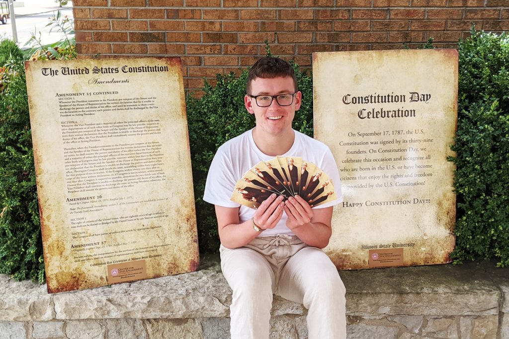 Joshua Crockett poses with copies of the Constitution
