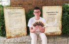 Joshua Crockett poses with copies of the Constitution