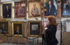 woman looking at portraits of presidents