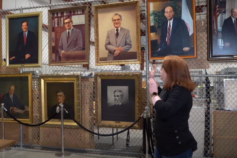woman looking at portraits of presidents