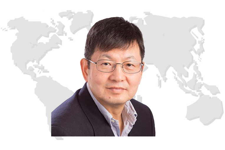Dr. Uk Heo's image with a world map in the background