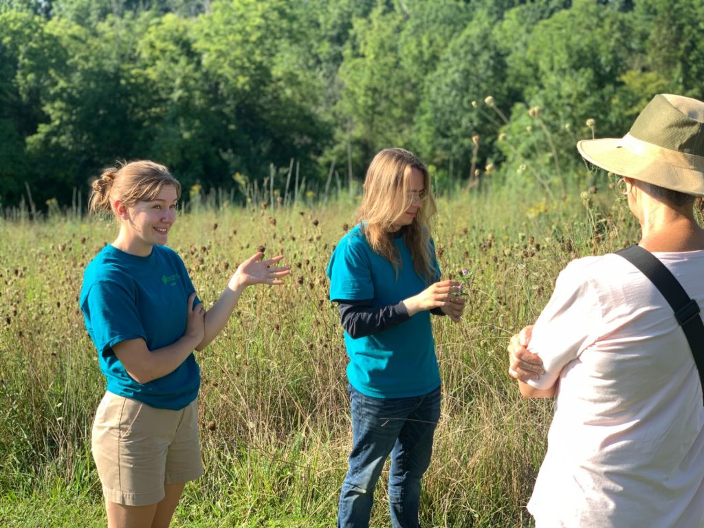 Allison Morgan, left, leads guided tours through the gardens' pollinator meadow at Yew Dell Botanical Gardens.