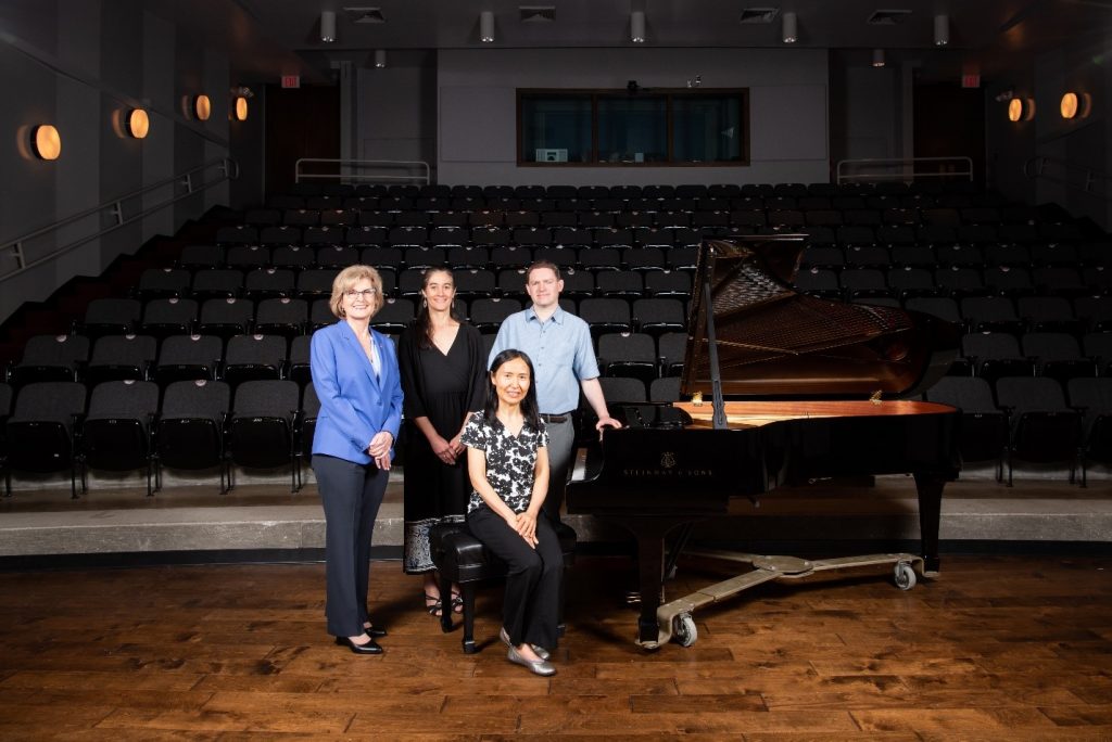 Dean Miller, Interim Director Adriana Ransom and Associate Professors of piano Tuyen Tonnu and Geoffrey Duce with one of the new Steinway concert grand model B pianos, Kemp Recital Hall