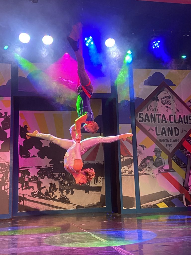 a pair of circus performers doing aerial tricks onstage