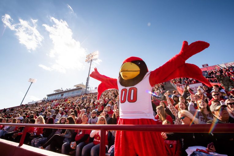 A mascot with its hands in the air.