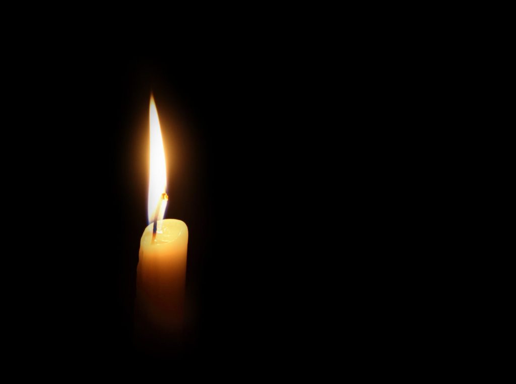 candle burning on a dark background