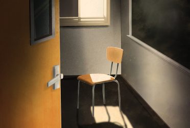 Lonely chair in empty school room draped in a single beam of sunglight