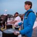 Close up photo of Rudy Morr playing a snare drum alongside other members of the drumline.