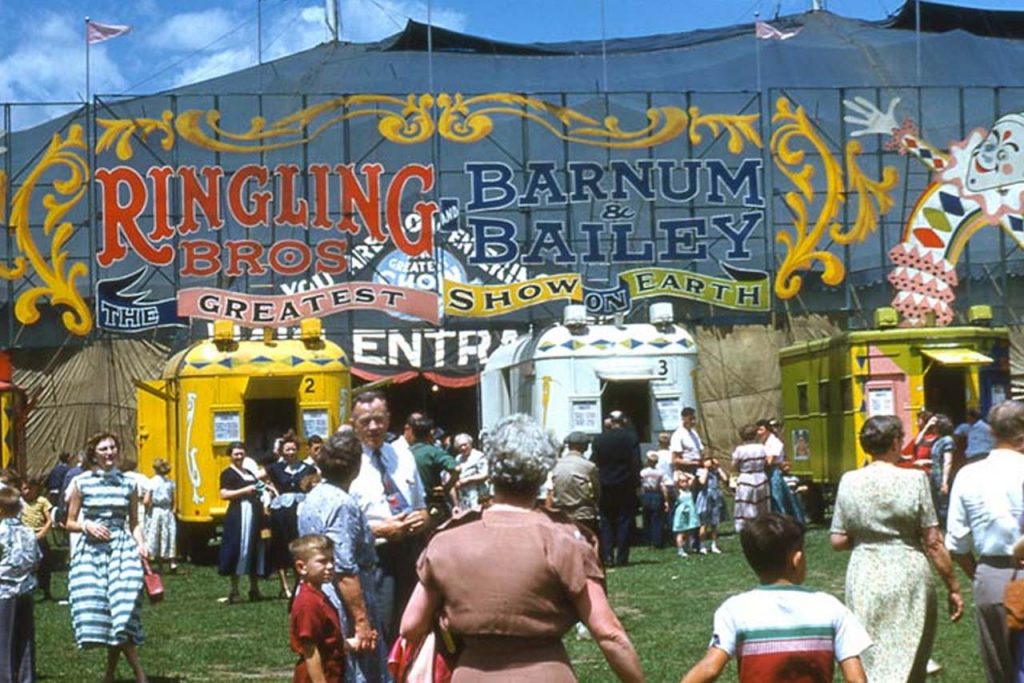 A digital reproduction of a photograph of the entrance of the Ringling & Barnum Bailey circus entrance with people walking in