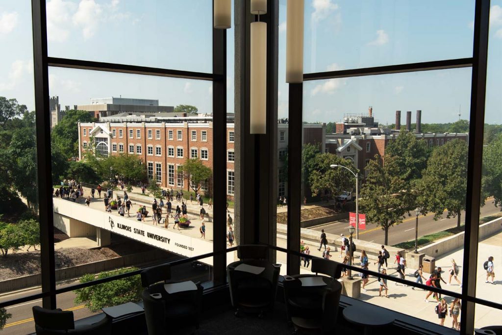 Photograph of the view out the fourth floor southwest windows at Milner Library overlooking students walking on the College Avenue Bridge