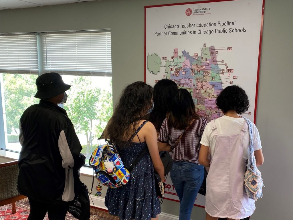 Students looking at teachers map.