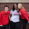 three students posed on campus
