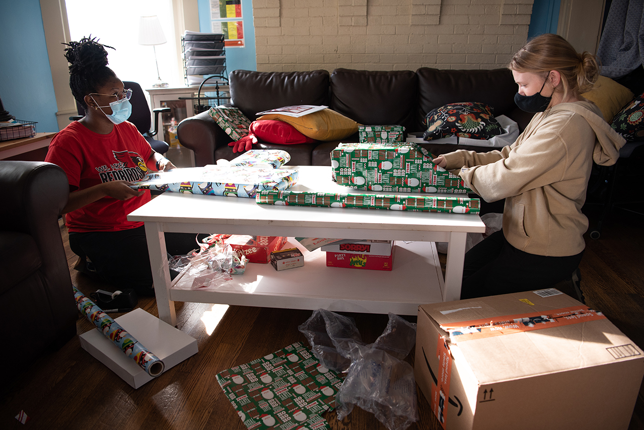 Shaniece Cole and Nikki Zavodny wrap donated Christmas presents for children at Hope House in Memphis.