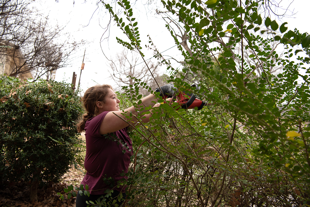 Senior Mikayla Foreman trims down a fence row of bushes adjacent to Jacob’s Ladder.
