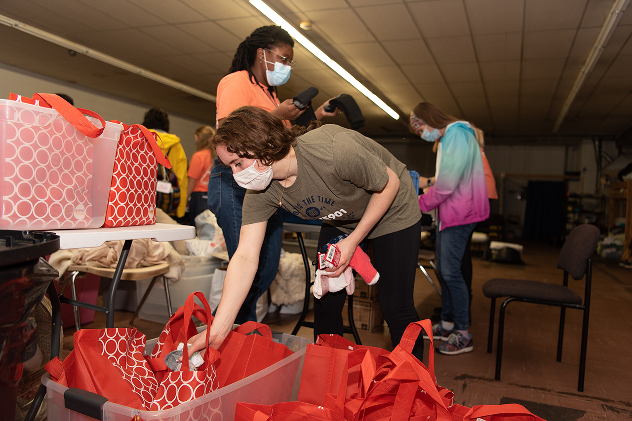Senior Lindsea Spiewak places cozy socks into care packages at a homeless shelter.