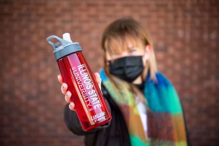 student holding water bottle