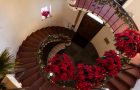 spiral staircase with flowers on railing