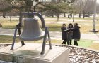 Campus community members ring Old Main bell on ISU's Quad