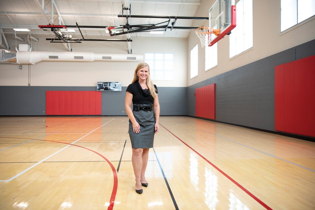 Dr. Emily Jones stands in a gymnasium