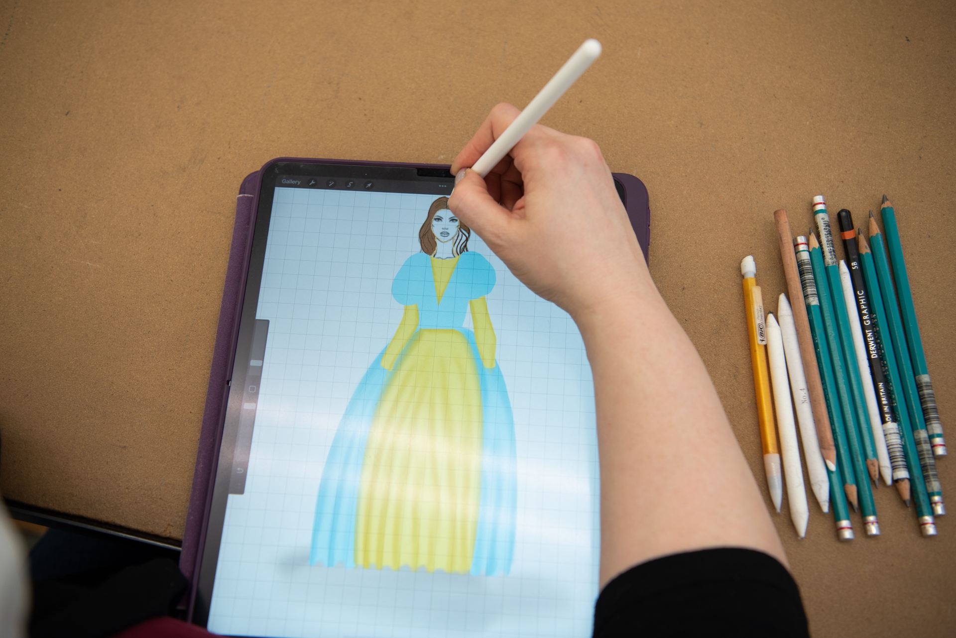A person sketching a costume on an iPad.