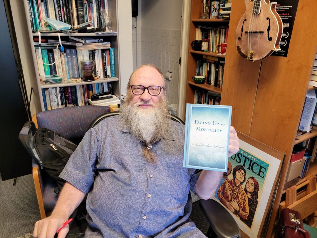 Social Work faculty, Dr. Liechty with his recent book.