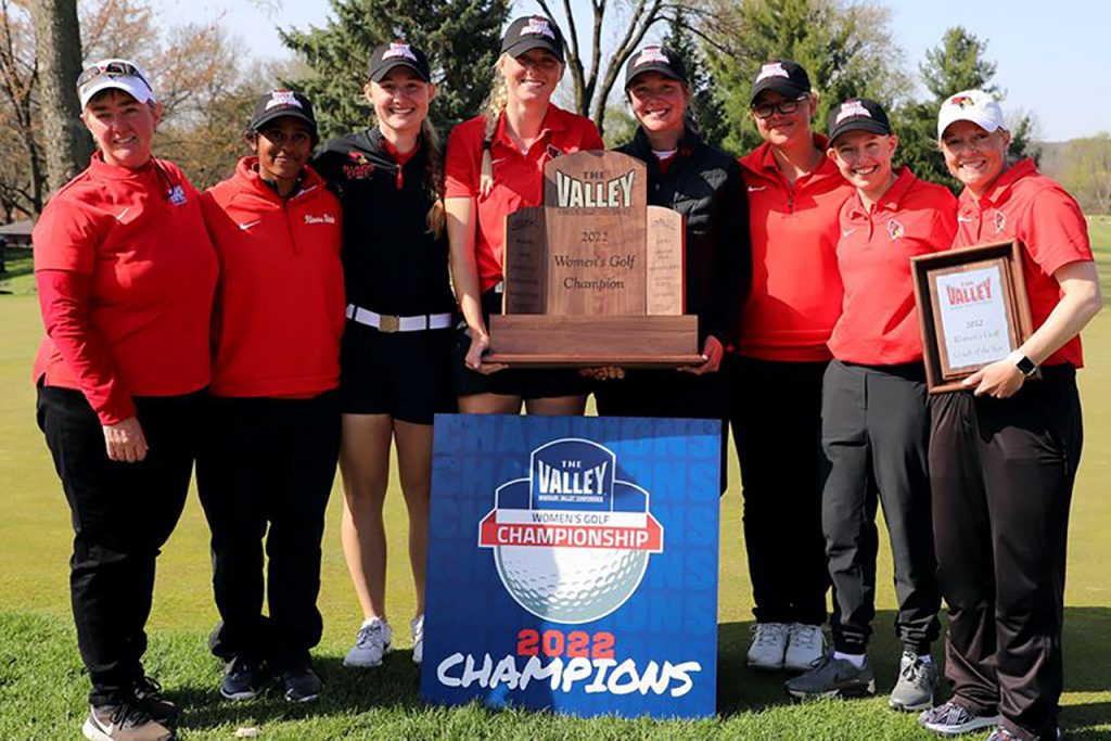 The Redbird women's golf team wins the 2022 Missouri Valley Conference title, stand with the trophy.
