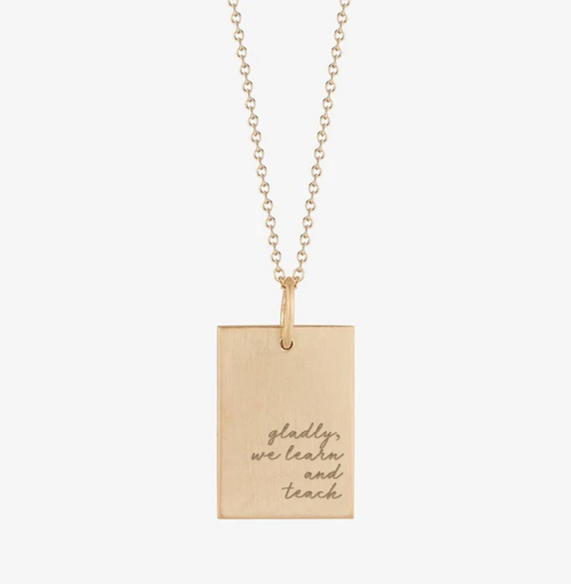 rectangular gold pendant necklace with text "gladly we learn and teach" engraved