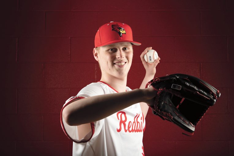 Redbird pitcher Trey Krause posing like he is about to throw a ball