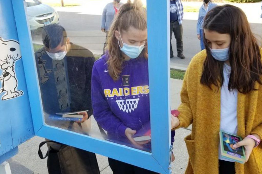 Students filling a Little Free Library