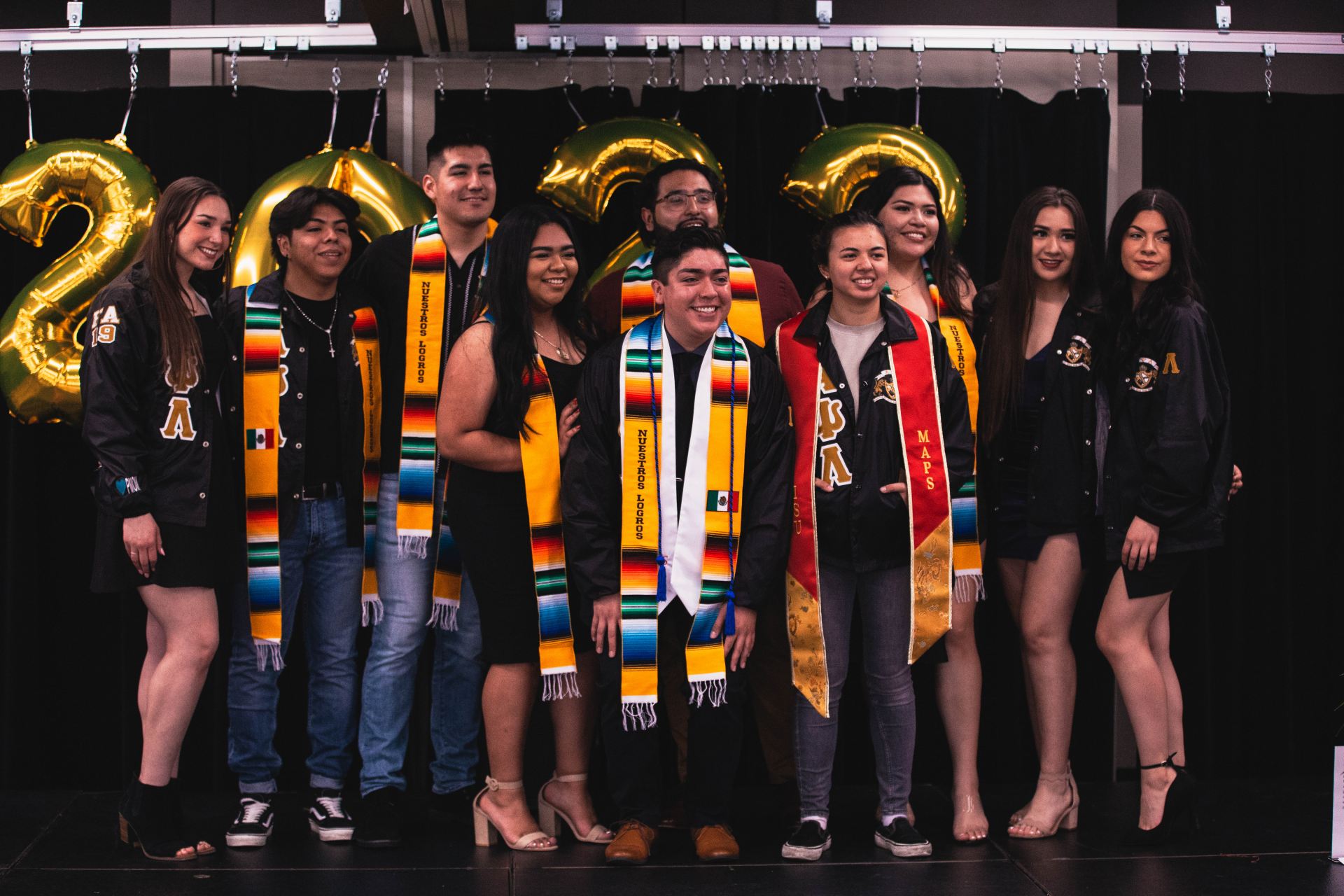 A group of graduates standing and posing together.