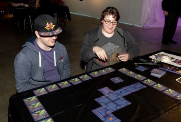 Two students playing a board game.