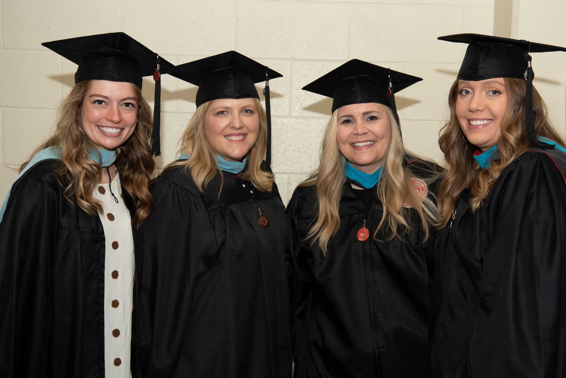 Four graduates standing next to each other.