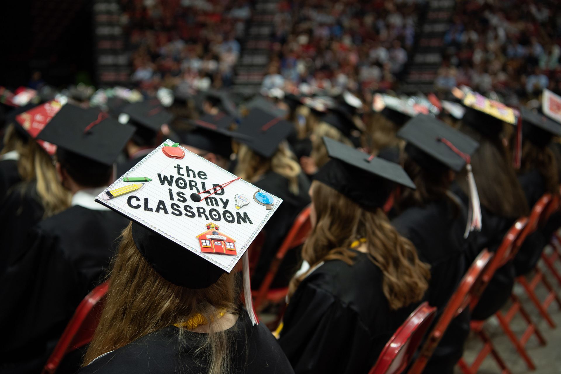 A persons graduating cap decorated with "the world is my classroom."
