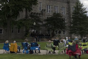 People gather outside of Cook Hall to listen to music during the 2021 Concert on the Quad series.