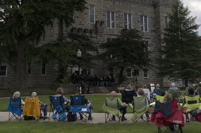 People gather outside of Cook Hall to listen to music during the 2021 Concert on the Quad series.