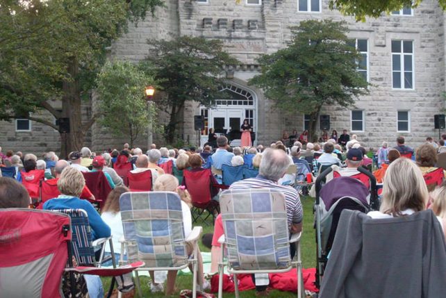 Patrons sit on blankets and lawn chairs in front of Cook Hall and listen to Illinois State University faculty and guests perform favorites from the Broadway and operatic stages during the annual favorite: Singing under the stars.