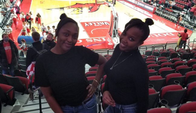 Graduate Students Vivian and Melon posing in the stands at an ISU women's redbird basketball game