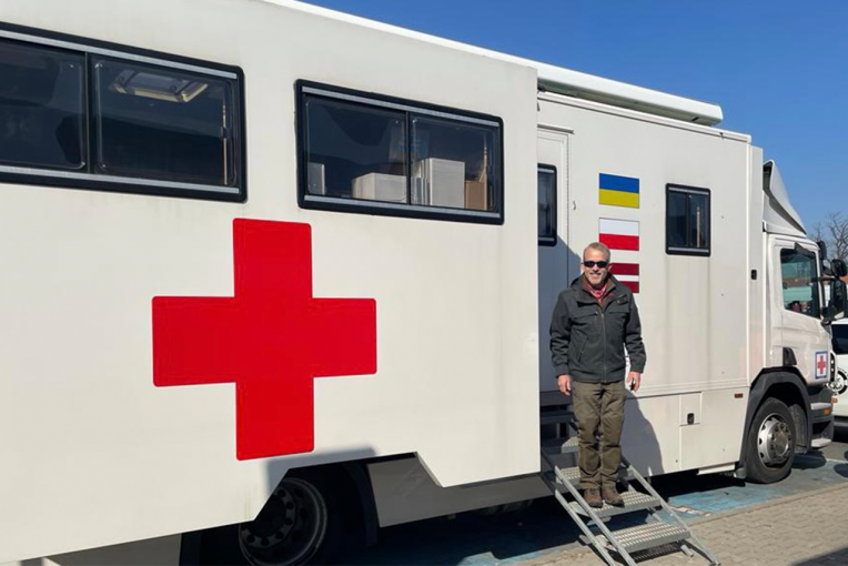 Man standing in front of medical truck
