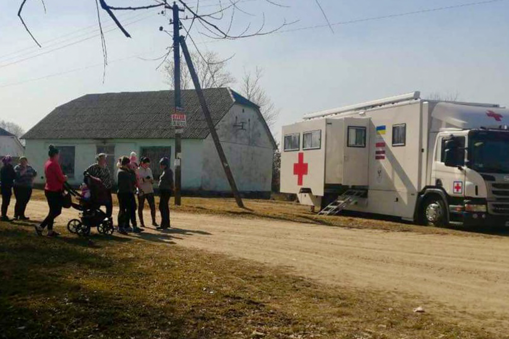 Medical truck with people standing near