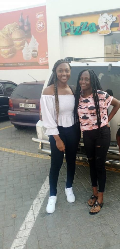 Vivian and her sister in the parking lot of the airport in Ghana
