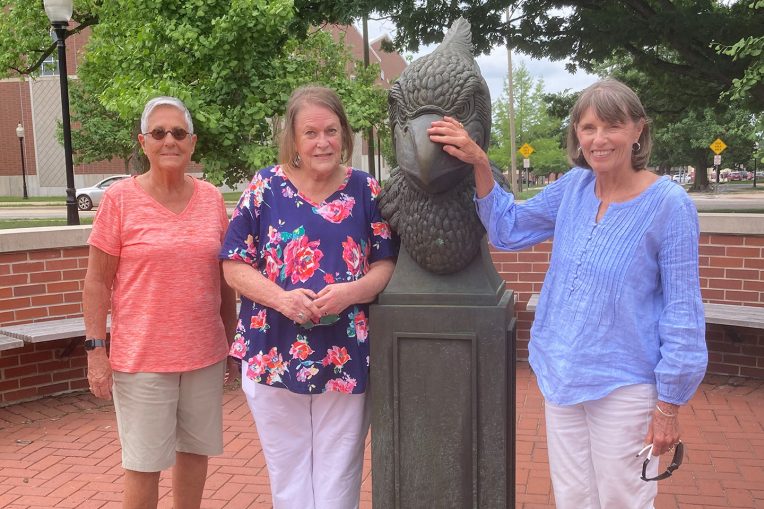 Kass, Linda, and Helen visiting the bust of Reggie on Redbird Plaza