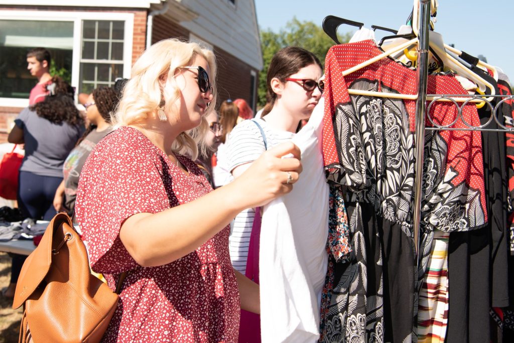 Students browse through a rack of clothes
