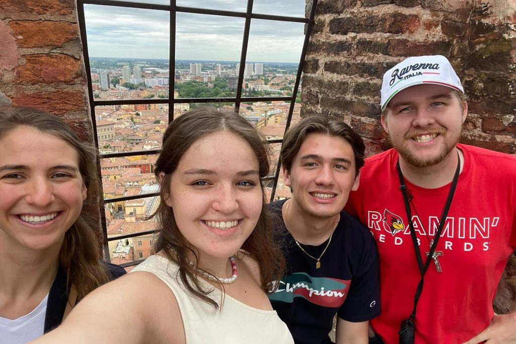 Four ISU students standing in front of Bologna cityscape